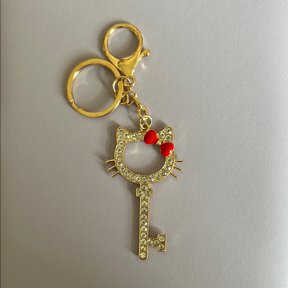 Gold Toned Hello Kitty Keychain with Red Bow